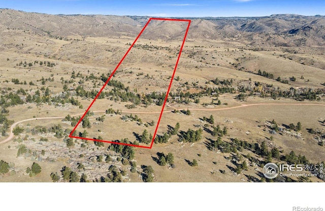 307 Brewster Ln, Livermore, CO 80536 - aerial view of sparsely populated area with property boundaries highlighted and a mountain backdrop