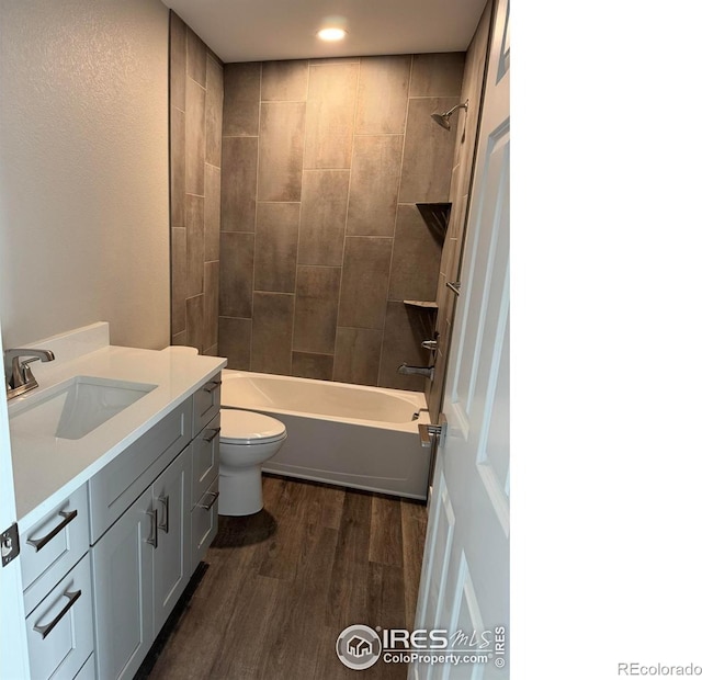 1687 Valency Dr, Loveland, CO 80537 - full bath with wood finished floors, toilet, bathtub / shower combination, vanity, and recessed lighting