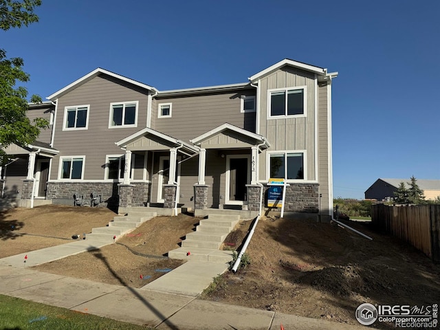 1687 Valency Dr, Loveland, CO 80537 - view of front of home featuring fence, stone siding, and board and batten siding