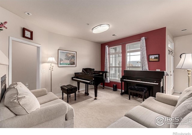 living area with light carpet, visible vents, and baseboards