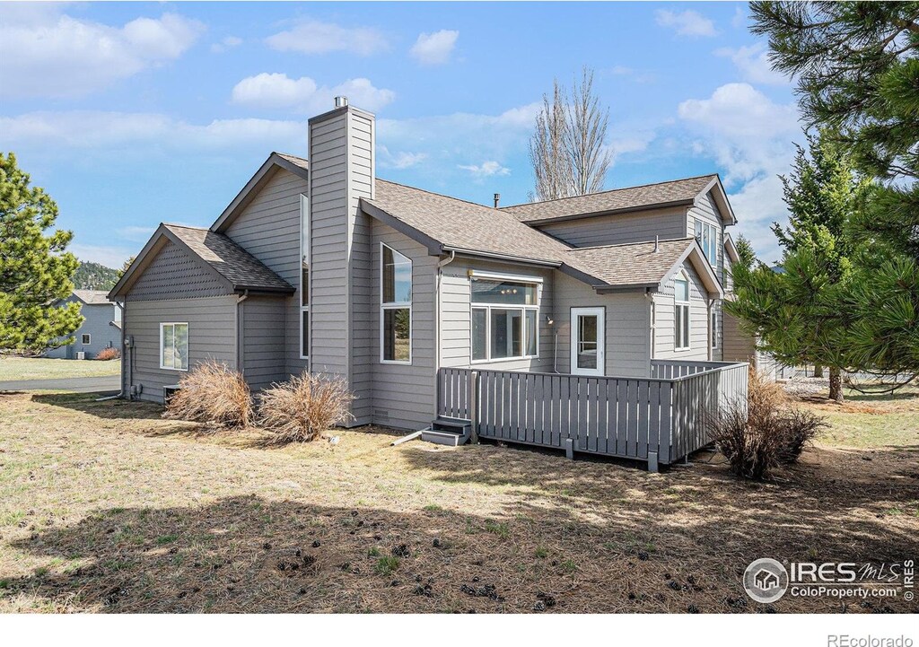 1505 Raven Cir, Estes Park, CO 80517 - back of house featuring a chimney, a deck, and a shingled roof