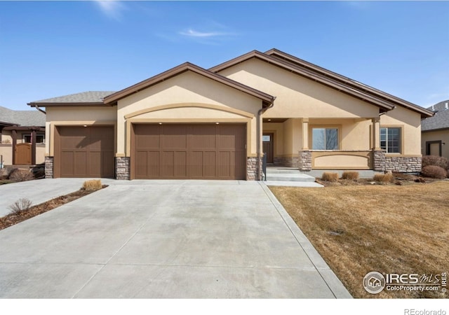 view of front facade featuring a garage, stone siding, concrete driveway, and stucco siding
