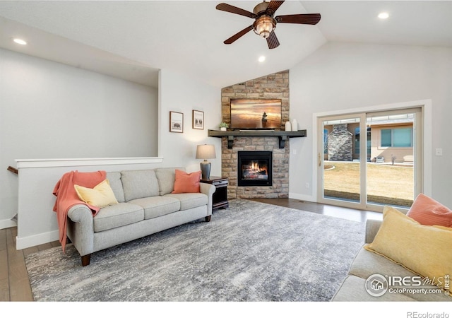 living area featuring a fireplace, wood finished floors, a ceiling fan, and baseboards