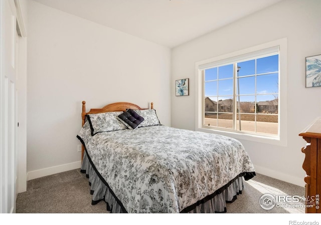 bedroom with carpet flooring and baseboards