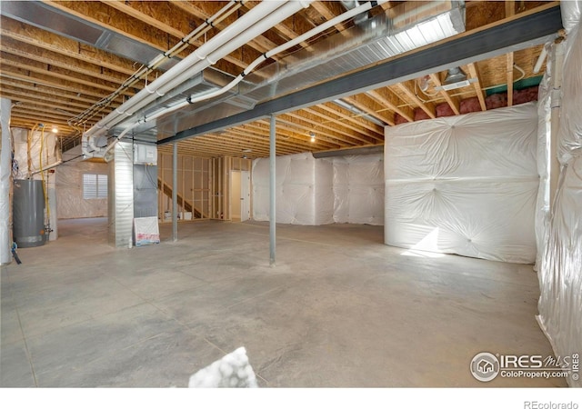 unfinished below grade area featuring water heater
