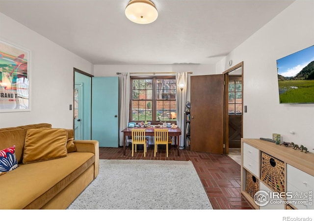 living area with brick floor