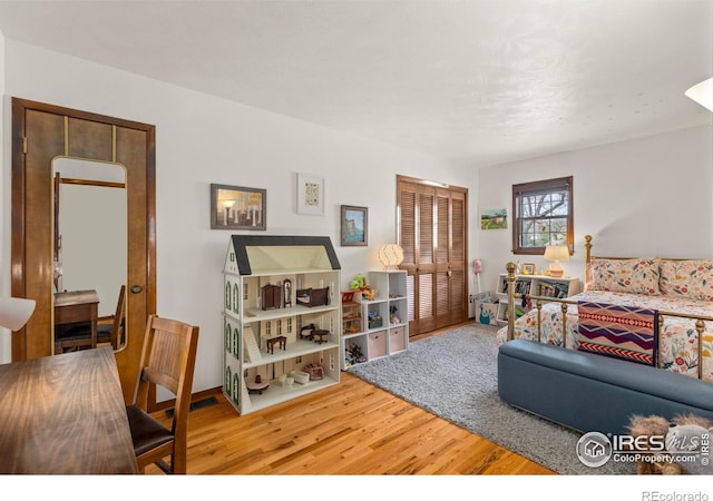living area with wood finished floors and visible vents