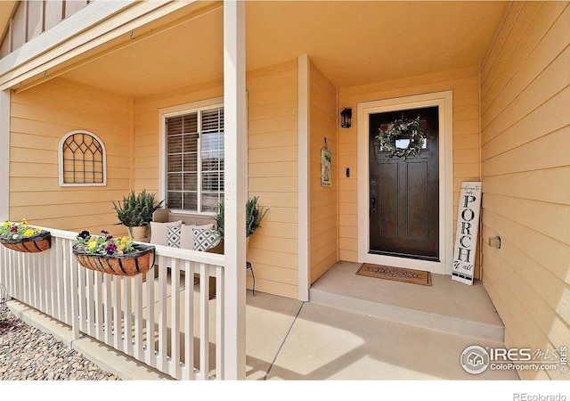 doorway to property with a porch