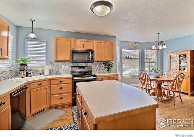 kitchen featuring a textured ceiling, decorative backsplash, stainless steel range with electric stovetop, light wood-style floors, and dishwasher