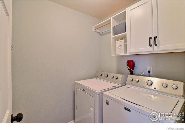 laundry area featuring washing machine and dryer and cabinet space
