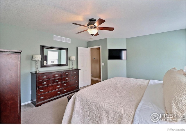 bedroom with carpet floors, a ceiling fan, visible vents, and baseboards