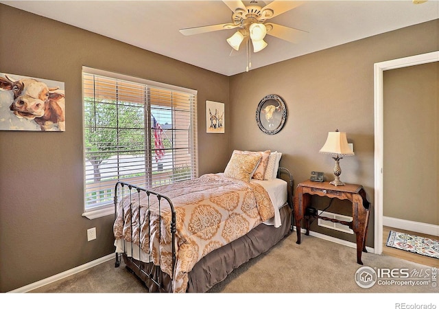carpeted bedroom featuring a ceiling fan and baseboards