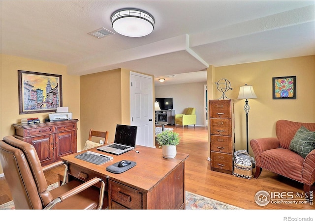 office space with light wood-style floors and visible vents
