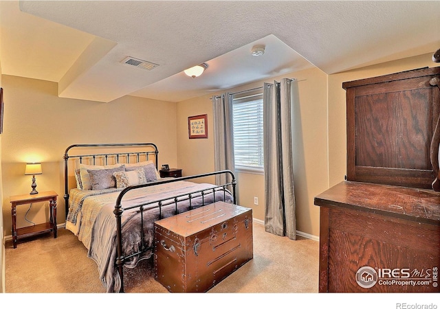 bedroom featuring light carpet, baseboards, and visible vents