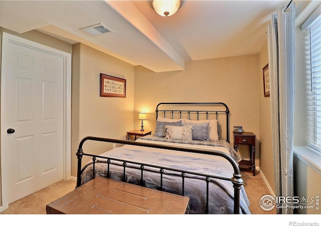 bedroom with baseboards, visible vents, and carpet floors