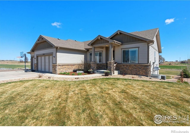 craftsman inspired home featuring board and batten siding, a front yard, stone siding, and a garage