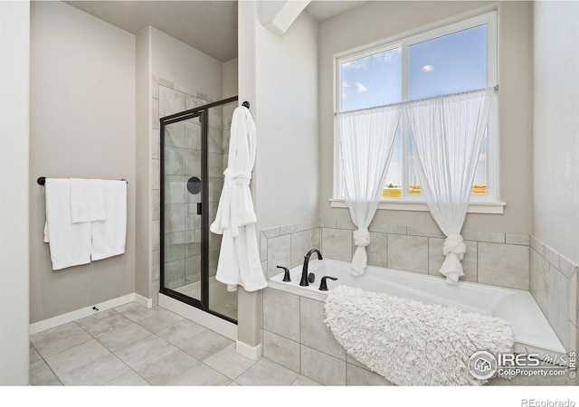 bathroom featuring a bath, a shower stall, a healthy amount of sunlight, and tile patterned flooring
