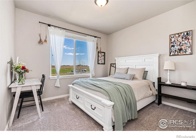 carpeted bedroom featuring baseboards