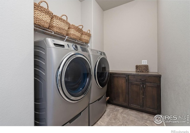 washroom featuring washing machine and clothes dryer and laundry area