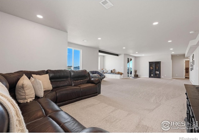carpeted living room with visible vents, recessed lighting, and a healthy amount of sunlight