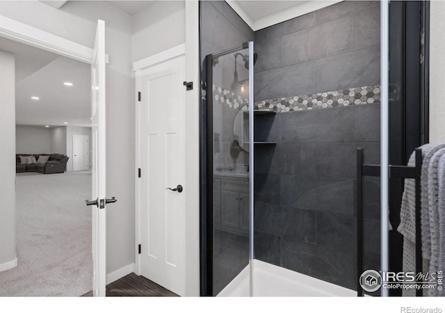 full bathroom with ensuite bath, a tile shower, baseboards, and recessed lighting