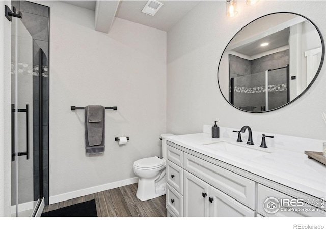 bathroom with a shower stall, wood finished floors, visible vents, toilet, and vanity