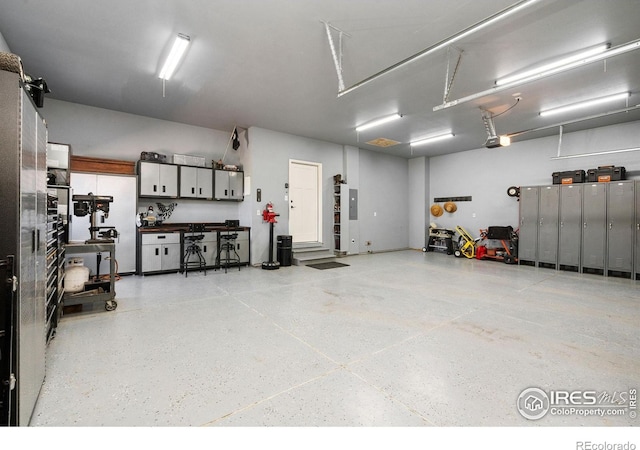 garage with a workshop area and a garage door opener