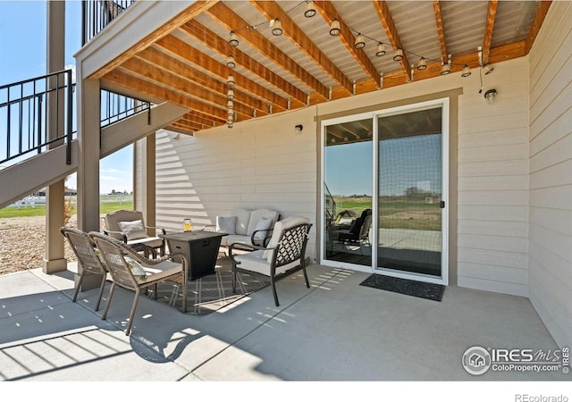 view of patio featuring an outdoor living space with a fire pit