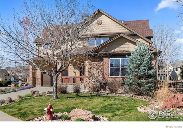 craftsman inspired home with concrete driveway, stone siding, covered porch, a front yard, and a garage