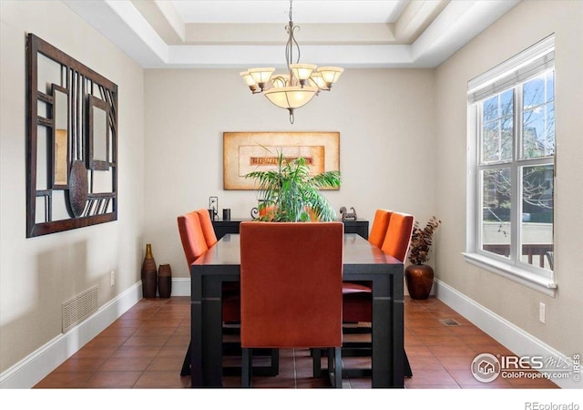 dining room featuring visible vents, tile patterned floors, and an inviting chandelier