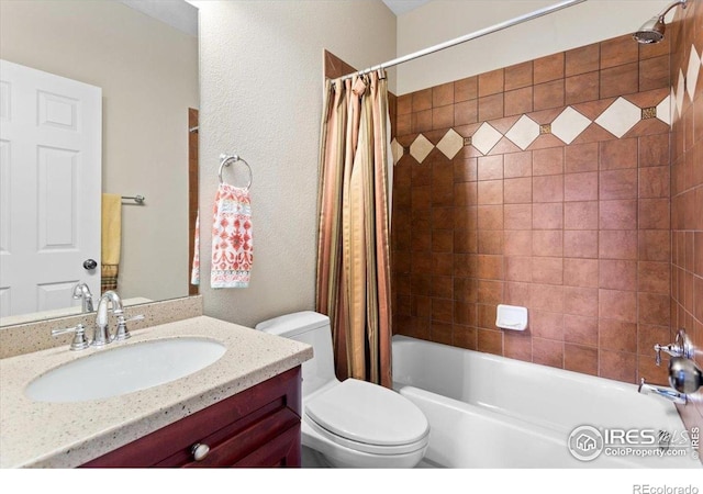 bathroom featuring shower / tub combo, toilet, and vanity