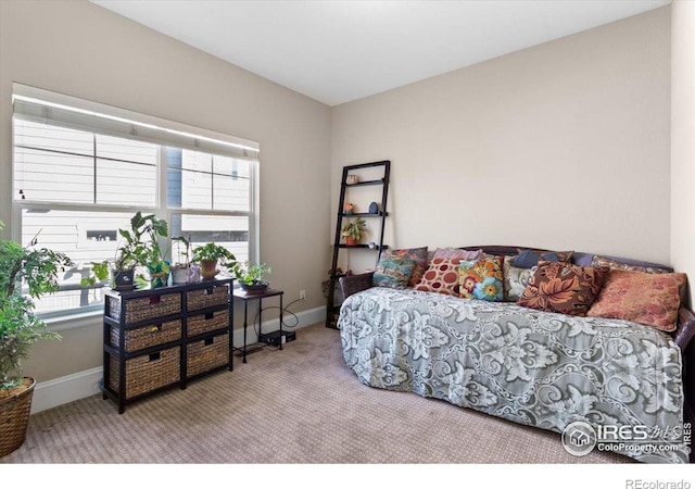 carpeted bedroom featuring baseboards