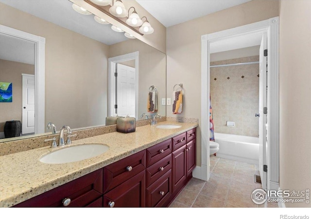 full bathroom with toilet, tile patterned floors, a sink, and double vanity