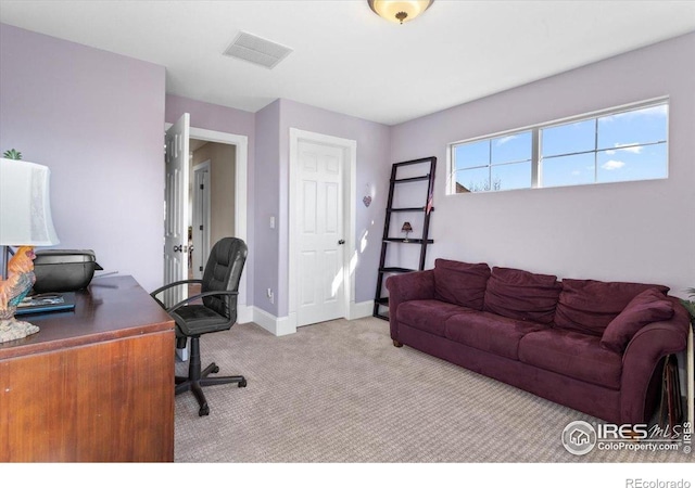 carpeted office space with visible vents and baseboards