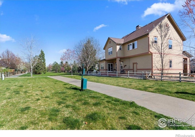 view of property exterior with fence and a yard