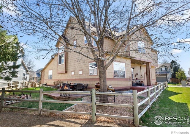 view of front of property with a front yard and fence