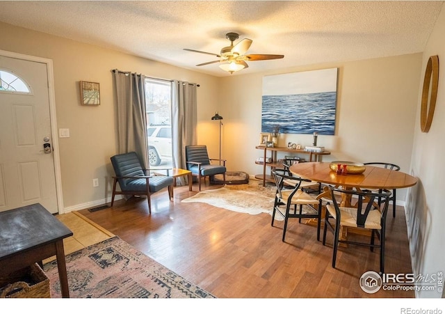 1504 Washington Ave, Louisville, CO 80027 - dining room with baseboards, a ceiling fan, wood finished floors, and a textured ceiling