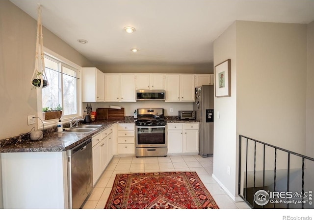 1504 Washington Ave, Louisville, CO 80027 - kitchen with dark countertops, light tile patterned floors, stainless steel appliances, and a sink