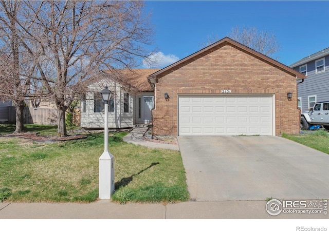 2131 Kay St, Longmont, CO 80501 - ranch-style house with an attached garage, driveway, brick siding, and a front yard
