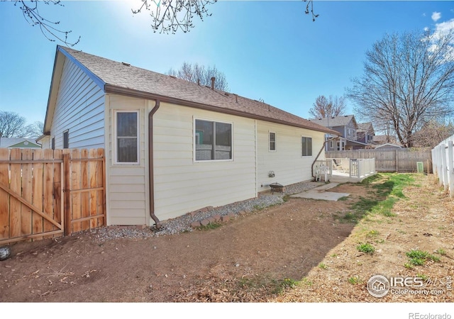 2131 Kay St, Longmont, CO 80501 - back of house with a shingled roof and a fenced backyard