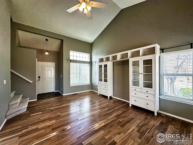 6502 Carmichael St, Fort Collins, CO 80528 - entryway featuring plenty of natural light, dark wood-style floors, high vaulted ceiling, a ceiling fan, and stairs