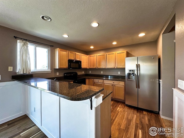 6502 Carmichael St, Fort Collins, CO 80528 - kitchen with a peninsula, recessed lighting, dark wood-style flooring, and black appliances