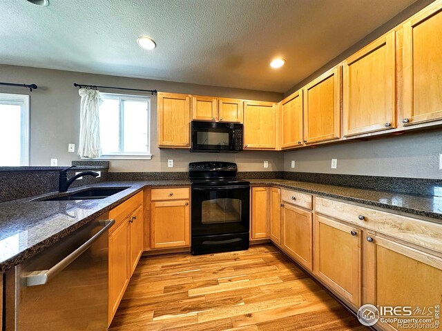 6502 Carmichael St, Fort Collins, CO 80528 - kitchen with a wealth of natural light, light wood finished floors, a sink, and black appliances