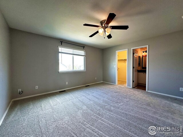 6502 Carmichael St, Fort Collins, CO 80528 - unfurnished bedroom with a spacious closet, carpet floors, and baseboards