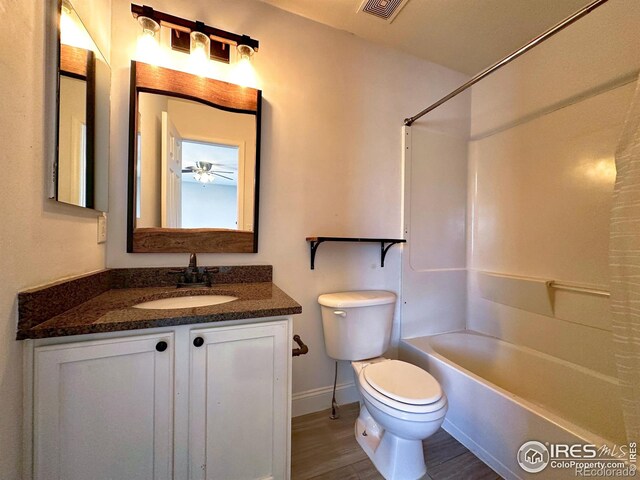 6502 Carmichael St, Fort Collins, CO 80528 - bathroom featuring wood finished floors, visible vents, toilet, vanity, and baseboards