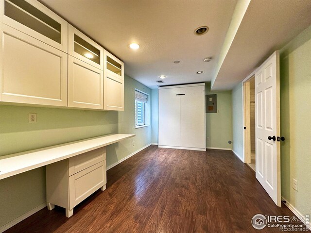 6502 Carmichael St, Fort Collins, CO 80528 - unfurnished office with baseboards, recessed lighting, dark wood-style floors, and built in desk