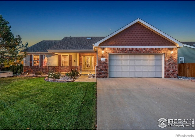 7421 18th St, Greeley, CO 80634 - single story home with a front lawn, driveway, covered porch, brick siding, and an attached garage