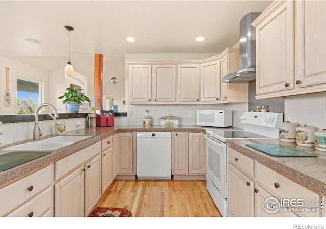 7421 18th St, Greeley, CO 80634 - kitchen featuring wall chimney range hood, a sink, white appliances, light wood-style floors, and decorative backsplash
