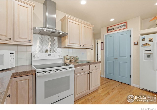 7421 18th St, Greeley, CO 80634 - kitchen with wall chimney exhaust hood, light wood finished floors, light brown cabinetry, tasteful backsplash, and white appliances