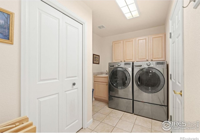 7421 18th St, Greeley, CO 80634 - clothes washing area with a sink, light tile patterned flooring, visible vents, independent washer and dryer, and cabinet space
